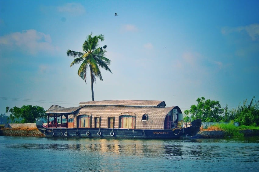 houseboat on river among exotic nature